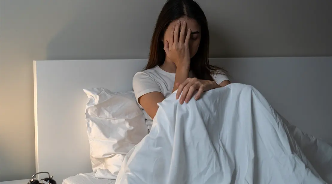 Woman in bed struggling to sleep